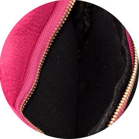 close up of the interior of the front compartment of a womens small pink leather bag 