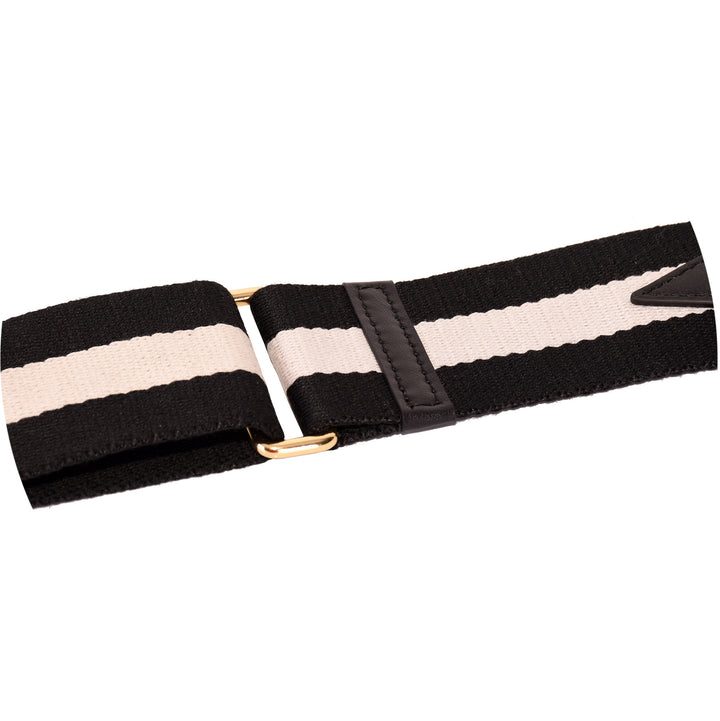 close up of the gold metal sliding buckle on a black & white stripe wide handbag strap