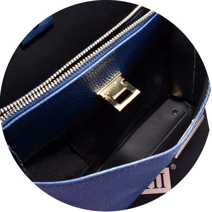 close up of the gold metal lift clasp on a womens dark blue italian leather large shoulder bag 
