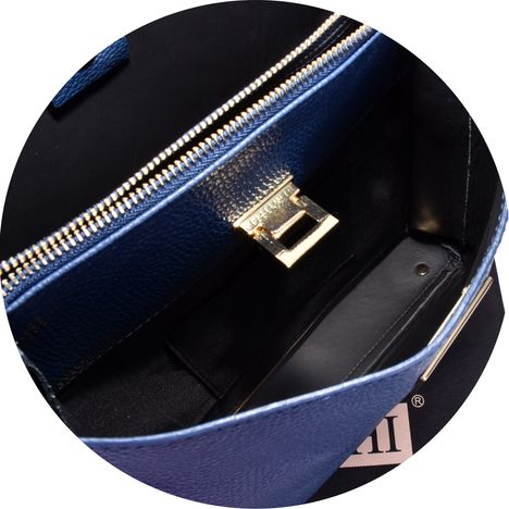 close up of the gold metal lift clasp on a womens dark blue italian leather large shoulder bag 