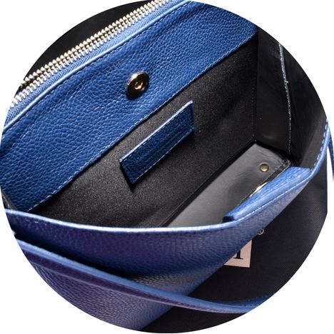 inside the large rear compartment with magnetic popper of a ladies blue leather grab & shoulder bag