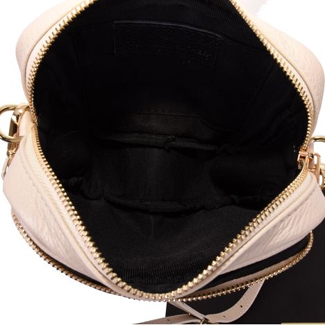 black interior of a womens small cream leather handbag that is open