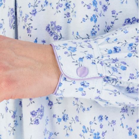 close up of cuff with satin trim and satin covered button on a womens blue brushed cotton nightdress
