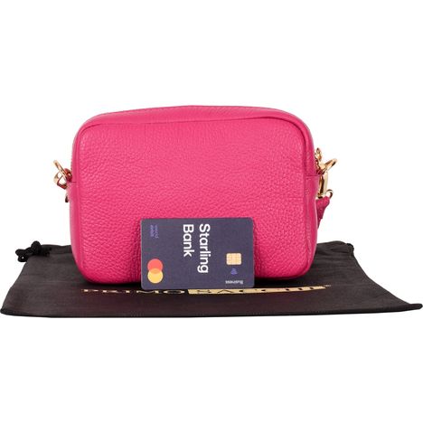 rear of womens small pink leather shoulder & crossbody bag with a debit card for size guidance