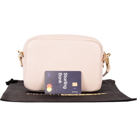 rear of womens small cream leather shoulder & crossbody bag with a debit card for size guidance