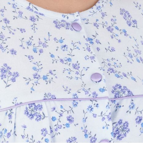 two lilac satin covered buttons on a womens blue floral brushed cotton winter nightdress