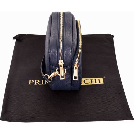 side and above view of a ladies small navy blue leather shoulder crossbody bag with gold zip