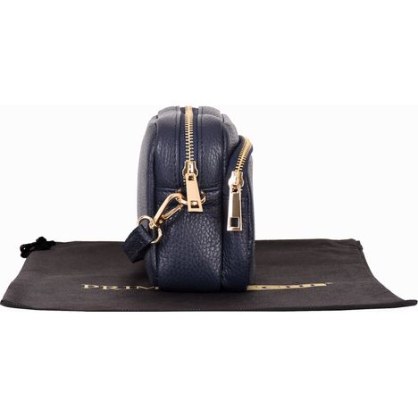 side view of a closed womens small navy leather shoulder crossbody bag with gold metalware 