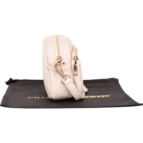 side view of a closed womens small cream leather shoulder crossbody bag with gold metalware 