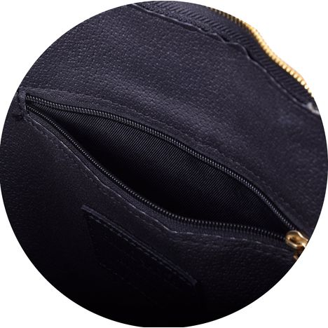 close up of the zipped internal pocket in a ladies large double handle black leather handbag