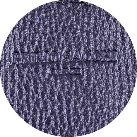 close up of embossed primo sacchi branding on a womens large black tote bag