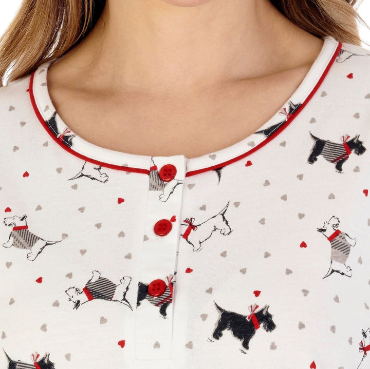  lowish round neck with red trim & red button placket of a cotton nightdress cream with scottie dog