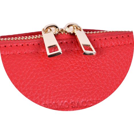 close up of two gold metal zip pullers on a womens large bright red leather bowling style handbag