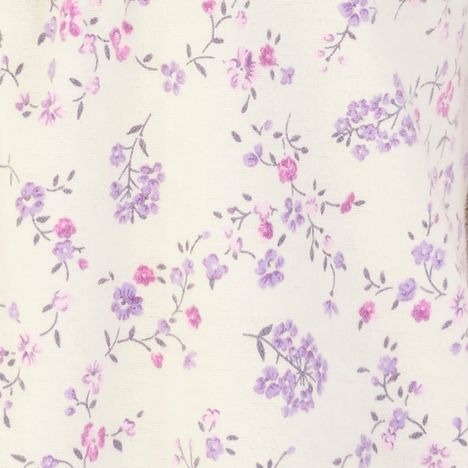 the small exquisite floral pattern in blue and lilac of a cream soft cotton nightdress