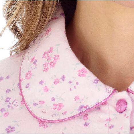 close up of a rounded collar with satin trim on an elderly ladies luxury pink winter nightdress