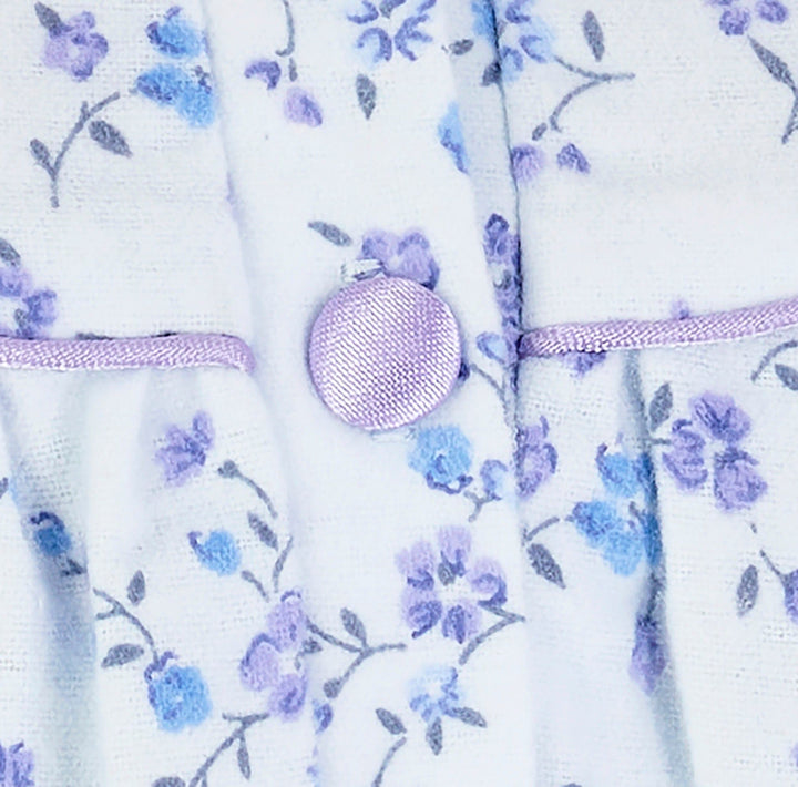 one of the four satin covered buttons on an elderly ladies luxury winter blue soft cotton nightdress