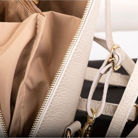 close up of a gold metal sliding buckle on the straps of the primo sacchi romana backpack shoulder bag crossbody bag and grab bag