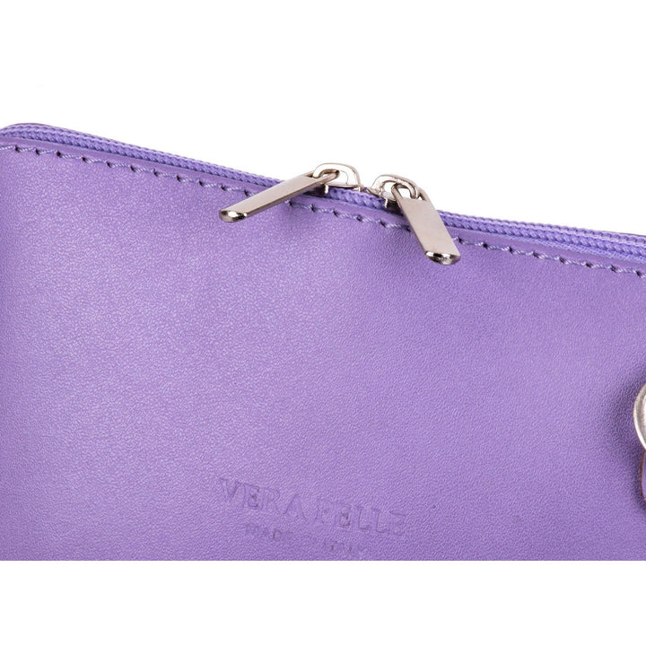 the two silver metal zip pullers on a womens lilac italian leather small shoulder crossbody bag