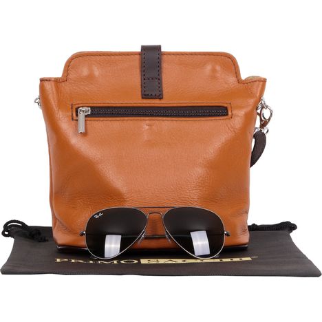 rear of small tan & dark brown soft leather handbag with aviator sunglasses as size guide 
